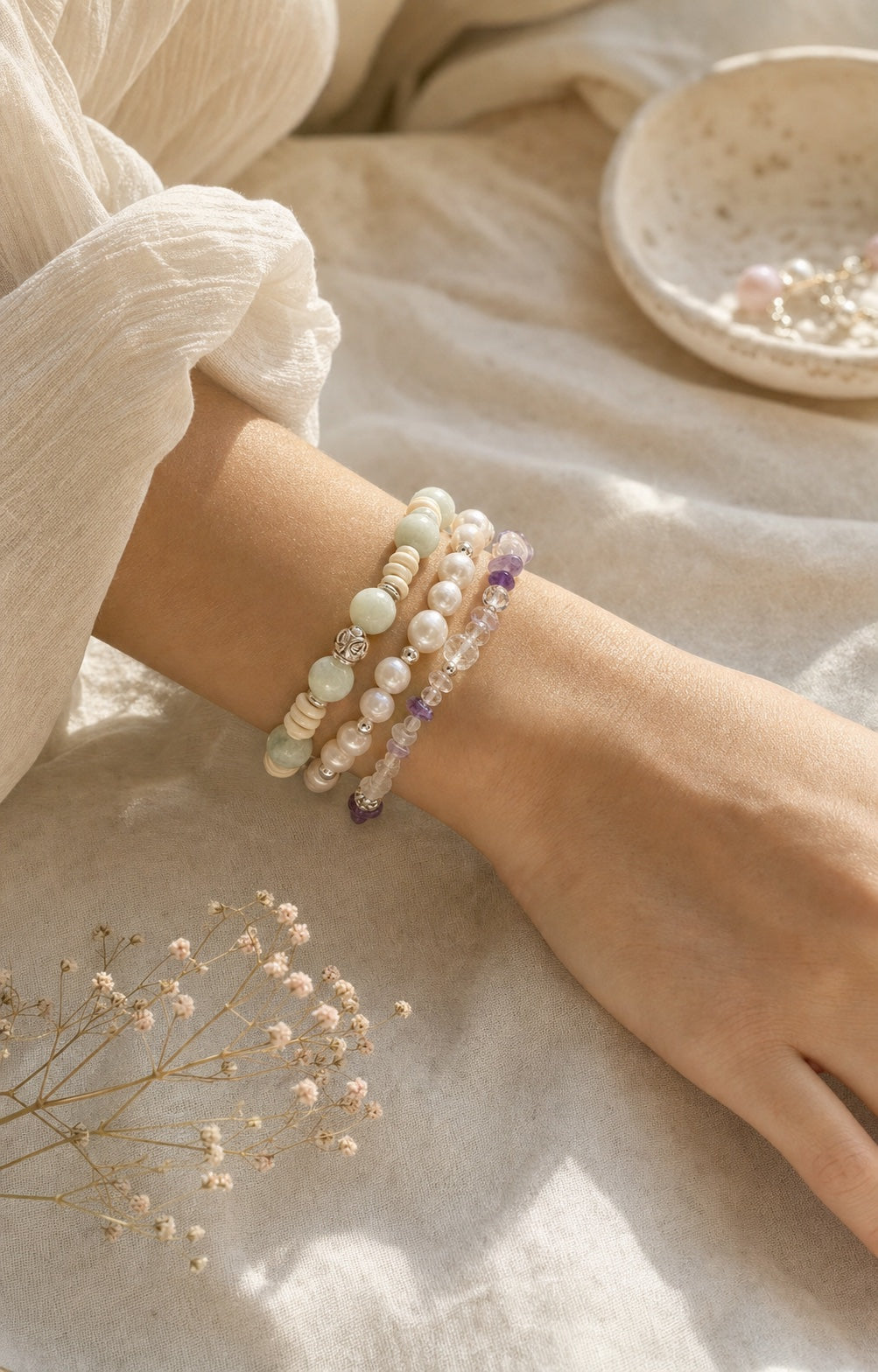 Wrist wearing handmade bead bracelets in warm natural light